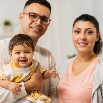 Couple holding baby after utilizing fertility services | Dallas IVF | Frisco TX
