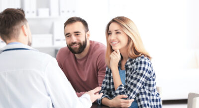 Couple consulting with fertility specialist discussing signs of infertility| Dallas IVF | Frisco, TX