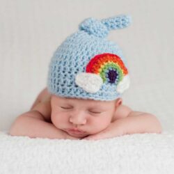 Rainbow baby (born from pregnancy after a miscarriage) wearing a blue rainbow hat | Dallas IVF