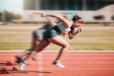 Elite, infertile athlete confidently participates in track meet after discussing her fertility challenges with a Dallas IVF fertility specialist