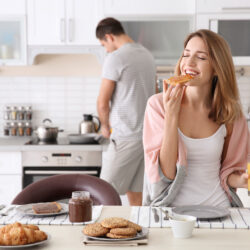 Young woman with celiac disease eating gluten free bread when trying to get pregnant to boost fertility | Dallas IVF | Frisco, TX