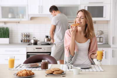 Young woman with celiac disease eating gluten free bread when trying to get pregnant to boost fertility | Dallas IVF | Frisco, TX