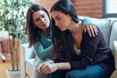 Woman comforts her friend while discussing mental health and PCOS | Dallas IVF